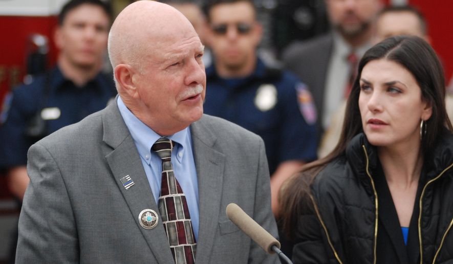 New Mexico state Reps. Bill Rehm, left, R-Albuquerque, and Dayan Hochman-Vigil, right, D-Albuquerque, speak Monday, Feb. 10, 2020, on the steps of the state Capitol building in favor of public safety legislation. They are co-sponsoring a bill with other Albuquerque-based lawmakers that aims to increase penalties for some felonies involving firearms, provide financial bonus for local law enforcement training in community-oriented policing and facilitate more treatment of first responders suffering from post traumatic stress. (AP Photo/Morgan Lee)