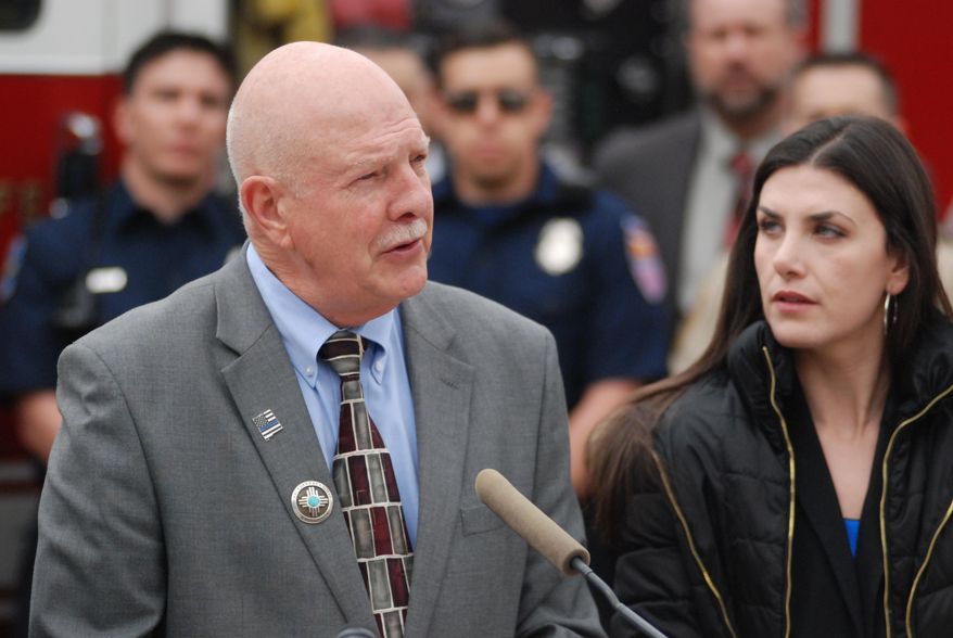 New Mexico state Reps. Bill Rehm, left, R-Albuquerque, and Dayan Hochman-Vigil, right, D-Albuquerque, speak Monday, Feb. 10, 2020, on the steps of the state Capitol building in favor of public safety legislation. They are co-sponsoring a bill with other Albuquerque-based lawmakers that aims to increase penalties for some felonies involving firearms, provide financial bonus for local law enforcement training in community-oriented policing and facilitate more treatment of first responders suffering from post traumatic stress. (AP Photo/Morgan Lee)