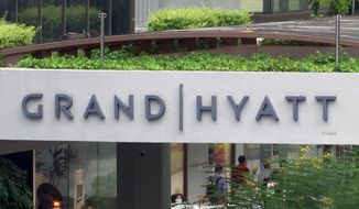 This image made from video shows the exterior of the Grand Hyatt hotel in Singapore, Monday, Feb. 10, 2020. A middle-aged businessman from southern England unwittingly carried the new virus across two continents and unwittingly infected at least 11 people in three countries, in just one example that illustrates how China&#x27;s outbreak could turn into a global pandemic amid fast-moving international travel. The businessman contracted the virus while attending a gas industry conference in the Grand Hyatt in Singapore in January. (AP Photo)