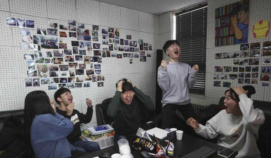 Film club members celebrate as they watch a TV live broadcasting of South Korean director Bong Joon Ho&#39;s &amp;quot;Parasite&amp;quot; receiving the award for best picture at the Oscars, at the Yeonsei University in Seoul, South Korea, Monday, Feb. 10, 2020. (AP Photo/Ahn Young-joon)