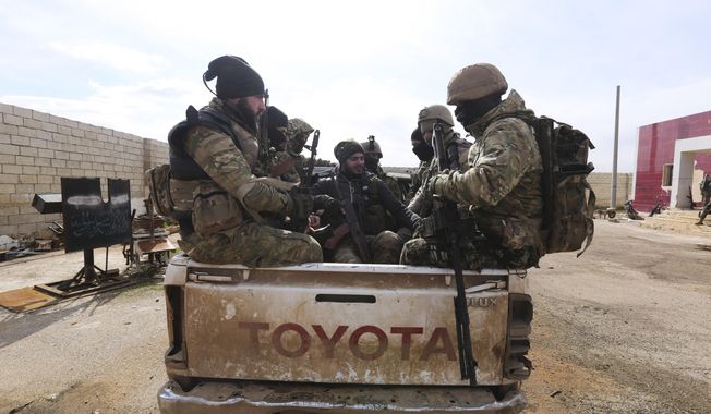 Turkish backed fighter prepare to go to the frontline in the Syrian province of Idlib, Monday, Feb. 10, 2020. The fighting in Idlib led to the collapse of a fragile cease-fire that was brokered by Turkey and Russia in 2018. Turkey supports the Syrian rebels, while Russia has heavily backed the Syrian government&#x27;s campaign to retake the area which is the last rebel stronghold in Syria. (AP Photo/Ghaith Alsayed)