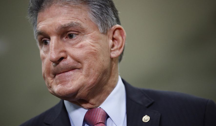 FILE - In this Feb. 5, 2020, file photo, Sen. Joe Manchin, D-W.Va., speaks with reporters after President Donald Trump was acquitted in an impeachment trial on charges of abuse of power and obstruction of Congress on Capitol Hill in Washington. A war of words between Trump and Manchin is heating up. The moderate Democrat took to cable news Monday, Feb. 10, to hurl barbs at the president after a weekend of back-and-forth that ignited when Trump criticized Manchin for voting to impeach him from office. (AP Photo/Patrick Semansky, File)