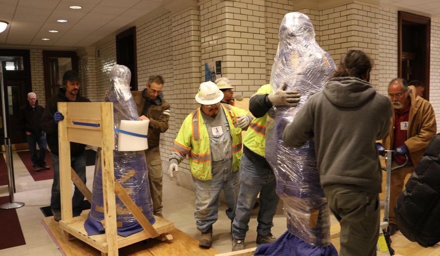 Statues of abolitionists Harriet Tubman and Frederick Douglass are moved into the Maryland State House on Monday, Jan. 27, 2020 in Annapolis, Md. The statues are being unveiled Monday night in the Old House Chamber, the room where slavery was abolished in Maryland in 1864. (AP Photo/Brian Witte)