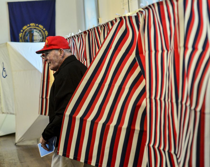 William J. Patenaude, a Korean and Vietnam veteran and resident of Chesterfield, N.H., leaves the voting booth with his ballot in hand at the Chesterfield, N.H., Polling Station inside the Town Hall during the New Hampshire presidential primary elections, Tuesday, Feb. 11, 2020. (Kristopher Radder/The Brattleboro Reformer via AP)