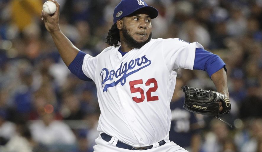 FILE - In this Tuesday, Oct. 16, 2018 file photo, Los Angeles Dodgers relief pitcher Pedro Baez throws during the sixth inning of Game 4 of the National League Championship Series baseball game against the Milwaukee Brewers in Los Angeles. Dodgers reliever Pedro Báez asked an arbitration panel for a raise to $4 million and Los Angeles argued during a hearing on Tuesday, Feb. 11, 2020 that he should be paid $3.5 million. (AP Photo/Jae Hong, File)