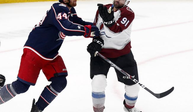 Colorado Avalanche forward Nazem Kadri, right, tries to catch the puck in front of Columbus Blue Jackets defenseman Vladislav Gavrikov, of Russia, during the third period of an NHL hockey game in Columbus, Ohio, Saturday, Feb. 8, 2020. (AP Photo/Paul Vernon)