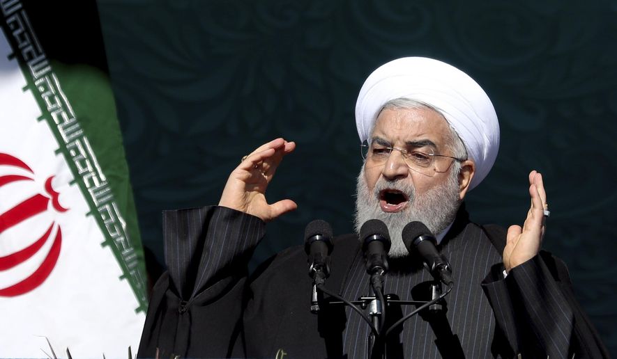 Iranian President Hassan Rouhani speaks during a ceremony celebrating the 41st anniversary of the Islamic Revolution, at the Azadi, Freedom, Square in Tehran, Iran, Tuesday, Feb. 11, 2020. Iranians took to the streets of Tehran and other cities and towns across the country on Tuesday for rallies and nationwide celebrations marking the anniversary of the 1979 Islamic Revolution when followers of Ayatollah Khomeini ousted U.S.-backed Shah Mohammad Reza Pahlavi. (AP Photo/Ebrahim Noroozi)
