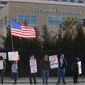 In this Feb. 11, 2017, file photo, pro-choice counterprotesters hold signs supporting a woman&#39;s right to choose abortion, as nearby anti-abortion activists held a rally in front of Planned Parenthood of the Rocky Mountains, in Denver. (AP Photo/Brennan Linsley, File)
