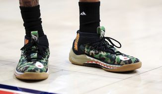 A view of the camouflage Adidas shoes worn by Rhode Island&#39;s Jeff Dowtin (11) in the first half in an NCAA college basketball game against Dayton, Tuesday, Feb. 11, 2020, in Dayton, Ohio. Dayton won 81-67. (AP Photo/Aaron Doster) ** FILE **