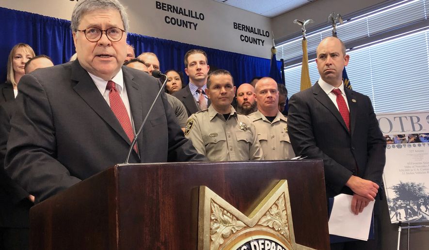 In this Nov. 12, 2019, photo, U.S. Attorney General William Barr, left, stands with other federal and officials at a news conference at the office of the Bernalillo County Sheriff in Albuquerque, N.M. New Mexico&#x27;s most populous city stands to lose out on millions of dollars in crime-fighting grants due to its status as a sanctuary city, but some elected officials said Wednesday, Feb. 12, 2020, the U.S. Justice Department is holding out the promise of more federal funding to get Albuquerque to reconsider policies that prevent the sharing of information with federal immigration authorities. The Justice Department has reached out to the Albuquerque Police Department about funds available under Operation Relentless Pursuit, the initiative announced in December by Attorney General William Barr to combat violent crime in seven of America&#x27;s most violent cities. (AP Photo/Mary Hudetz) **FILE**
