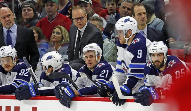 Winnipeg Jets head coach Paul Maurice, center, watches from the bench during the third period of an NHL hockey game against the Carolina Hurricanes in Raleigh, N.C., Tuesday, Jan. 21, 2020. (AP Photo/Karl B DeBlaker)