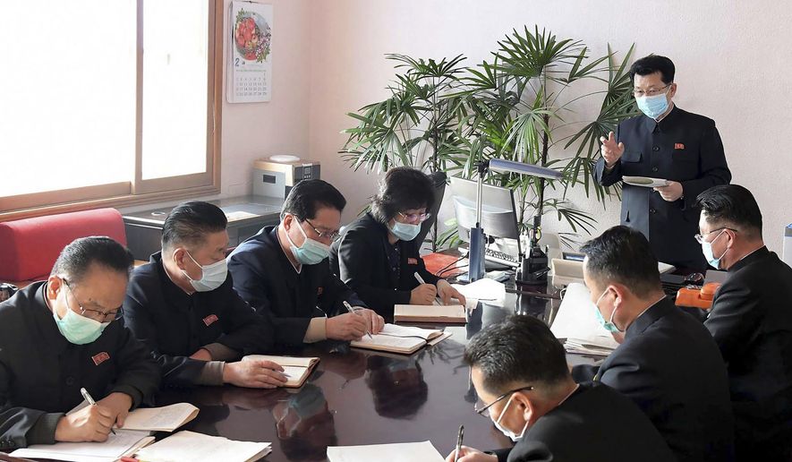 In this undated photo distributed on Wednesday, Feb. 12, 2020, by the North Korean government, North Korean Premier Kim Jae Ryon, right top, has a meeting at the emergency anti-epidemic headquarter in Pyongyang, North Korea. Independent journalists were not given access to cover the event depicted in this image distributed by the North Korean government. The content of this image is as provided and cannot be independently verified. (Korean Central News Agency/Korea News Service via AP)