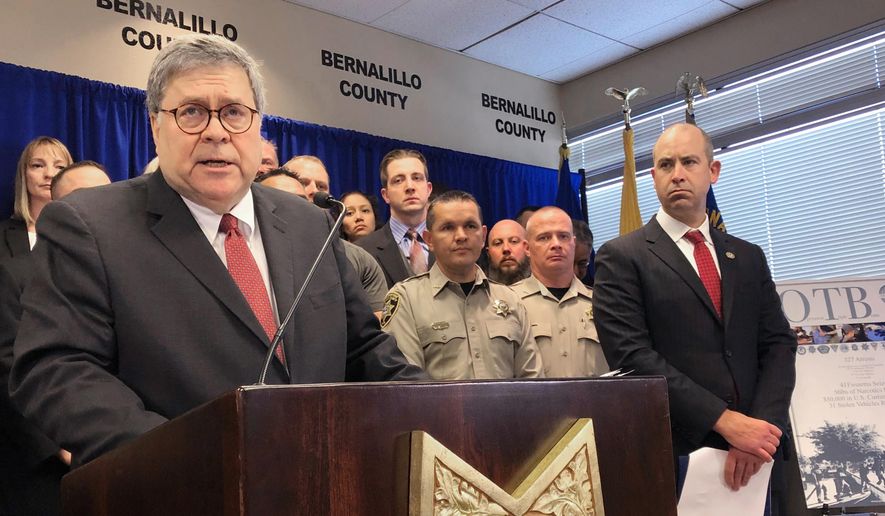 In this Nov. 12, 2019, file photo, U.S. Attorney General William Barr, left, stands with other federal and officials at a news conference at the office of the Bernalillo County Sheriff in Albuquerque, N.M. (AP Photo/Mary Hudetz, File)