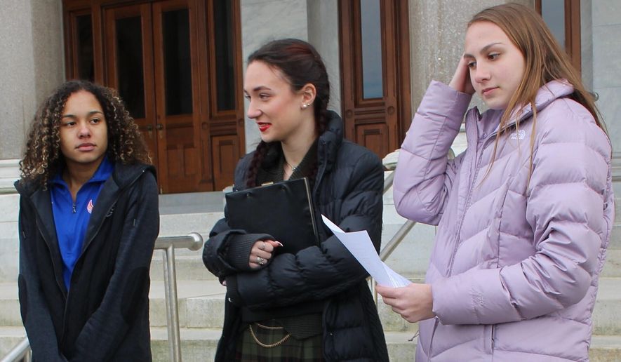 High school track athletes Alanna Smith, left, Selina Soule, center and and Chelsea Mitchell prepare to speak at a news conference outside the Connecticut State Capitol in Hartford, Conn. Wednesday, Feb. 12, 2020. The three girls have filed a federal lawsuit to block a state policy that allows transgender athletes to compete in girls sports. (AP Photo/Pat Eaton-Robb)