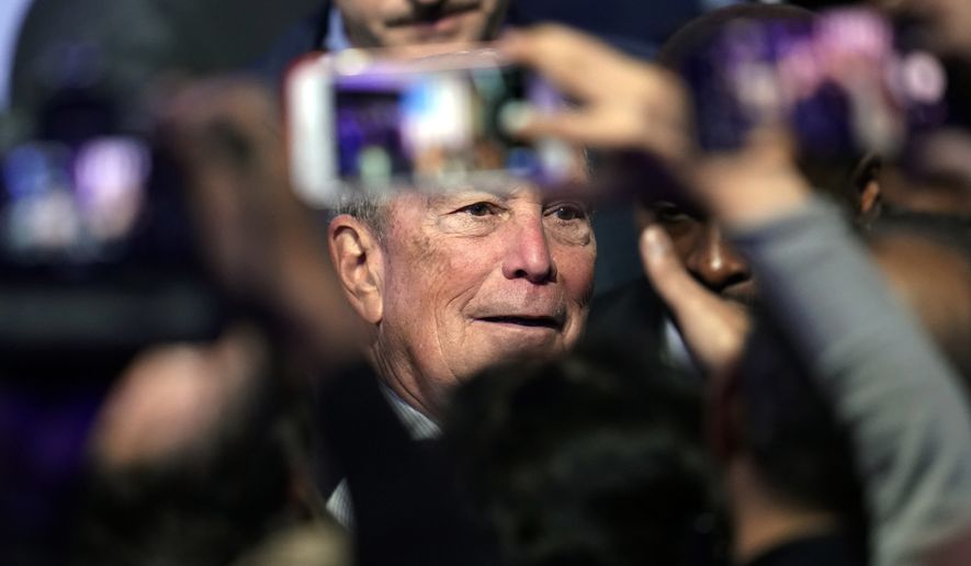 Democratic presidential candidate and former New York City Mayor Michael Bloomberg poses for photographs with supporters during his campaign launch of "Mike for Black America," at the Buffalo Soldiers National Museum, Thursday, Feb. 13, 2020, in Houston. (AP Photo/David J. Phillip)