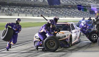 Denny Hamlin comes in for a pit stop during the first of two NASCAR Daytona 500 qualifying auto races at Daytona International Speedway, Thursday, Feb. 13, 2020, in Daytona Beach, Fla. (AP Photo/Terry Renna)