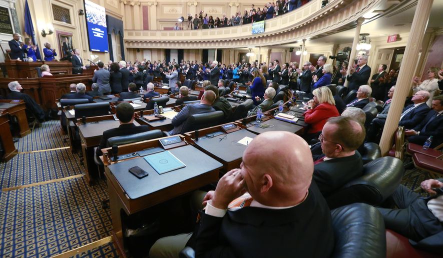 FILE - In this Jan. 8, 2020 file photo, House Republicans sit in their seats as Democratic lawmakers applaud Virginia Gov. Ralph Northam as he delivers his State of the Commonwealth address before a joint session of the Assembly at the state Capitol in Richmond, Va. Some criminal justice activists are disappointed by the number of reform proposals that have stalled in Virginia's legislature this year, despite a new Democratic majority. (AP Photo/Steve Helber, File)