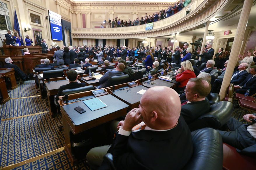 FILE - In this Jan. 8, 2020 file photo, House Republicans sit in their seats as Democratic lawmakers applaud Virginia Gov. Ralph Northam as he delivers his State of the Commonwealth address before a joint session of the Assembly at the state Capitol in Richmond, Va. Some criminal justice activists are disappointed by the number of reform proposals that have stalled in Virginia's legislature this year, despite a new Democratic majority. (AP Photo/Steve Helber, File)