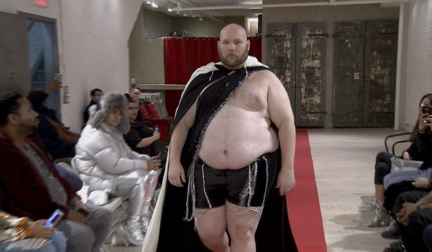 Joseph Diaz walks the runway in a fashion show Wednesday, Feb. 12, 2020, aimed at shining a light on male body shaming issues and the importance of the male body positivity movement. (AP Photo/Aron Ranen)