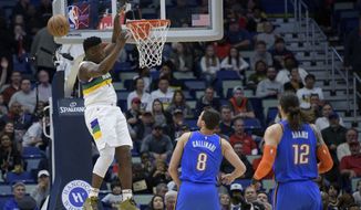 New Orleans Pelicans forward Zion Williamson (1) can&#39;t grab a pass at the basket, next to Oklahoma City Thunder forward Danilo Gallinari (8) during the first half of an NBA basketball game in New Orleans, Thursday, Feb. 13, 2020. (AP Photo/Matthew Hinton)