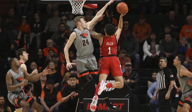 Oregon State&#x27;s Kylor Kelley (24) blocks a shot by Utah&#x27;s Timmy Allen (1) during the first half of an NCAA college basketball game in Corvallis, Ore., Thursday, Feb. 13, 2020. (AP Photo/Amanda Loman)