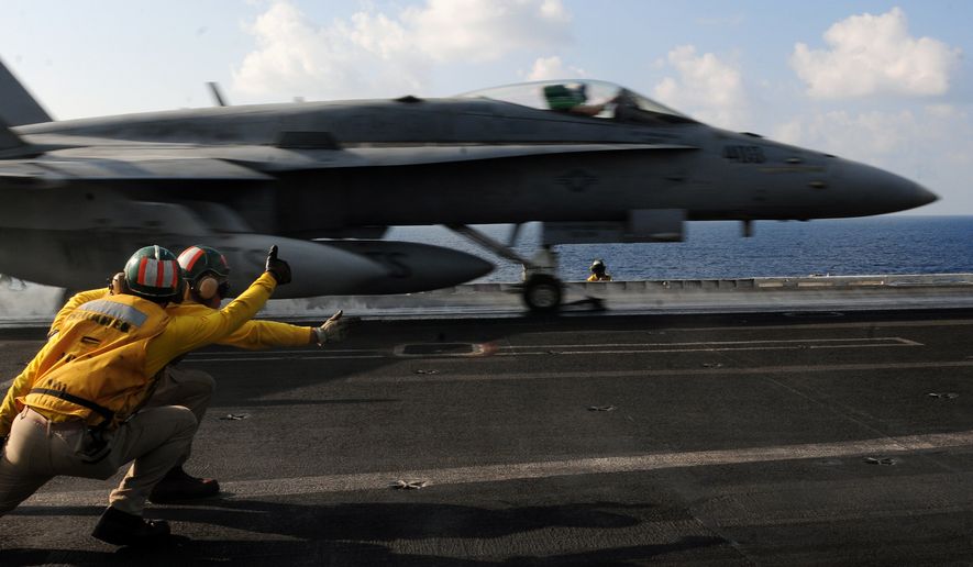 ARABIAN SEA(Nov. 25, 2012) Aircraft launch and recovery officers launch an F/A-18C Hornet assigned to the Wildcats of Strike Fighter Squadron (VFA) 131 from the flight deck of the Nimitz-class aircraft carrier USS Dwight D. Eisenhower. (U.S. Navy photo)