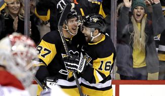 Pittsburgh Penguins&#39; Jason Zucker (16) celebrates his goal with Sidney Crosby (87) during the second period of the team&#39;s NHL hockey game against the Montreal Penguins in Pittsburgh, Friday, Feb. 14, 2020. (AP Photo/Gene J. Puskar)