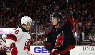 Carolina Hurricanes&#x27; Andrei Svechnikov (37), of Russia, celebrates his goal as he skates by New Jersey Devils&#x27; Andy Greene (6) during the second period of an NHL hockey game in Raleigh, N.C., Friday, Feb. 14, 2020. (AP Photo/Karl B DeBlaker)