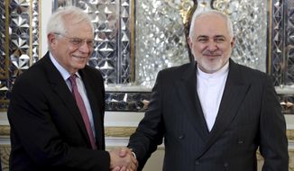FILE - In this Monday, Feb 3, 2020, file photo, Iranian Foreign Minister Mohammad Javad Zarif, right, and European Union foreign policy chief Josep Borrell, shake hands for journalists prior to their meeting, in Tehran, Iran. Now that Britain has left the bloc, the EU hopes to find more time concentrate on its foreign policy. (AP Photo/Ebrahim Noroozi, File)
