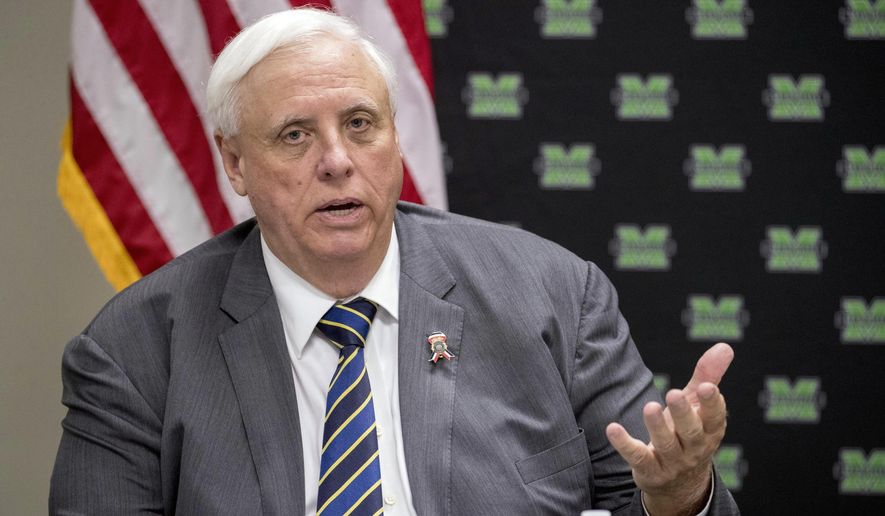 In this July 8, 2019, file photo, West Virginia Gov. Jim Justice speaks at a roundtable in Huntington, W.Va. West Virginia Gov. Jim Justice has offered a conditional apology for calling a high school girls basketball team “thugs," saying he didn't know the remarks would cause any trouble. The Republican governor on Friday, Feb. 14, 2020 told WCHS-TV he was sorry if he did anything to offend the team. (AP Photo/Andrew Harnik, File) **FILE**