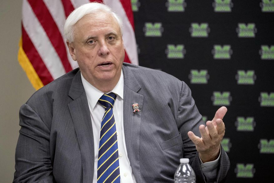 In this July 8, 2019, file photo, West Virginia Gov. Jim Justice speaks at a roundtable in Huntington, W.Va. West Virginia Gov. Jim Justice has offered a conditional apology for calling a high school girls basketball team “thugs," saying he didn't know the remarks would cause any trouble. The Republican governor on Friday, Feb. 14, 2020 told WCHS-TV he was sorry if he did anything to offend the team. (AP Photo/Andrew Harnik, File) **FILE**