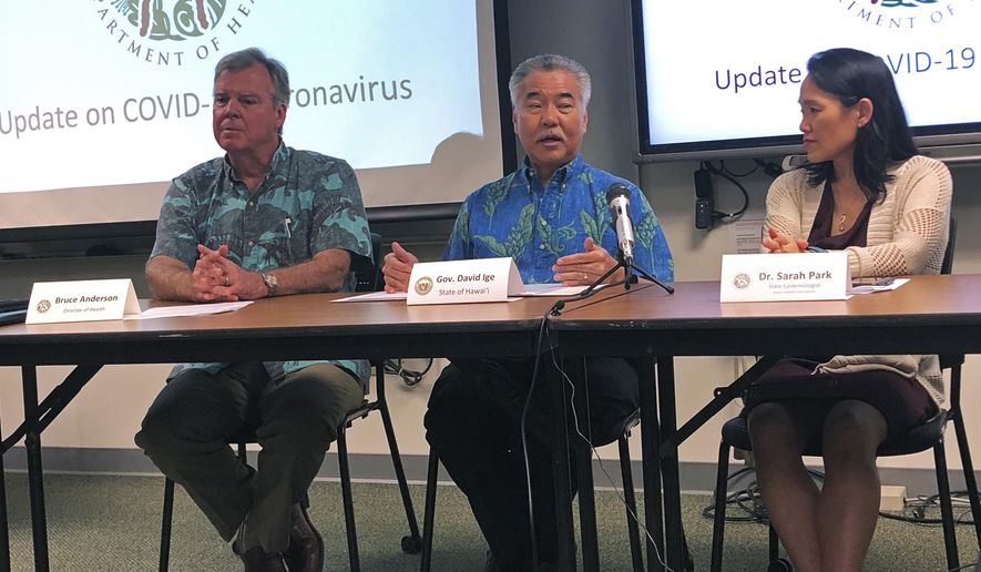 Hawaii Gov. David Ige, center, state Health Director Bruce Anderson, left, and state Epidemiologist Sarah Park, right, discuss a tourist who was confirmed with the coronavirus after returning home to Japan at a news conference in Honolulu on Friday, Feb. 14, 2020. Hawaii officials are trying to learn more about who was in close contact with the man and other details about his time in the islands. (AP Photo/Jennifer Sinco Kelleher)