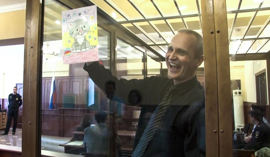 FILE In this file image taken from video, on Thursday, May 23, 2019 Dennis Christensen shows a picture in a court room in Oryol, Russia, Thursday, May 23, 2019. Two Jehovah's Witnesses were convicted of extremism in Russia and four more arrested, one of whom reported being tortured in custody. Russia officially banned Jehovah’s Witnesses in 2017 and declared the group an extremist organization. Crackdown on the group has intensified since then. (AP Photo, File)