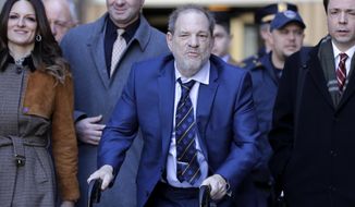 Harvey Weinstein, center, leaves a Manhattan courthouse after closing arguments in his rape trial in New York, Friday, Feb. 14, 2020. (AP Photo/Seth Wenig)