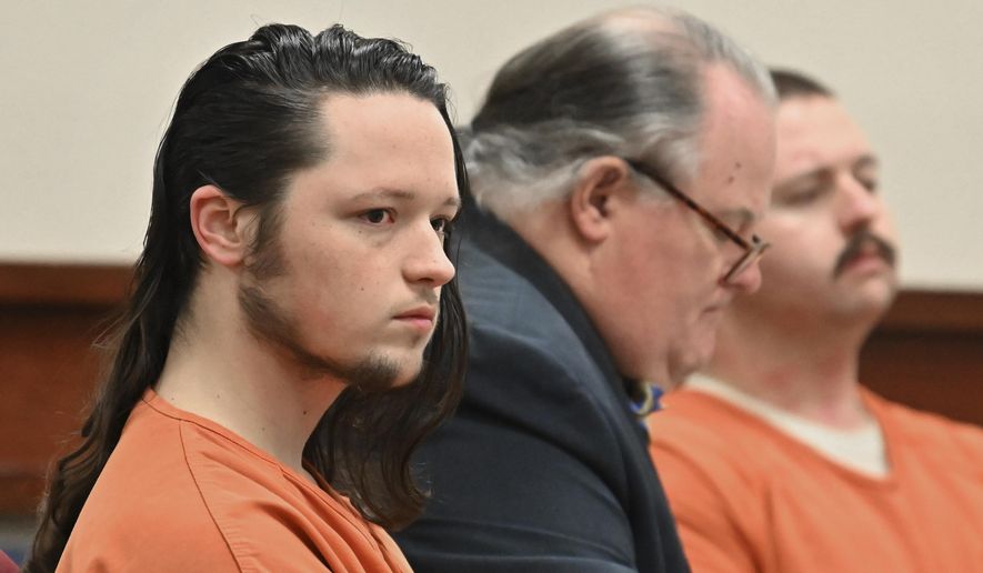 Jacob Kaderli, left, and Michael Helterbrand, right, sit with Helterbrand's attorney Radford Bunker as Kaderli's attorney John Lovell (not pictured) speaks before Floyd County Superior Court Judge Jack Niedrach (not pictured) during their bond hearing at Floyd County Superior Court in Rome, Ga., on Friday, Feb. 14, 2020. Bond was denied Friday for the two Georgia men authorities say are linked to a violent white supremacist group known as The Base. The two men are charged, along with 22-year-old Luke Lane of Silver Creek, of conspiring to kill members of a militant anti-fascist group and participating in a criminal gang. (Hyosub Shin/Atlanta Journal-Constitution via AP)
