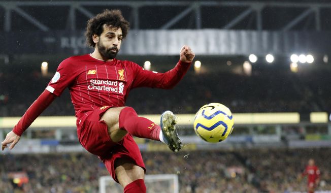 Liverpool&#x27;s Mohamed Salah kicks the ball during the English Premier League soccer match between Norwich City and Liverpool at Carrow Road Stadium in Norwich, England, Saturday, Feb. 15, 2020. (AP Photo/Frank Augstein) ** FILE **