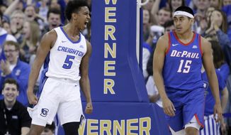 DePaul&#39;s Oscar Lopez Jr. (15) watches as Creighton&#39;s Ty-Shon Alexander (5) celebrates a dunk during the first half of an NCAA college basketball game in Omaha, Neb., Saturday, Feb. 15, 2020. (AP Photo/Nati Harnik)