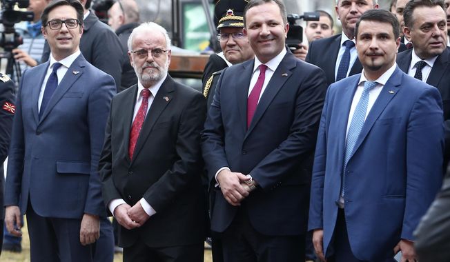 From left, North Macedonia&#x27;s head officials: President Stevo Pendarovski, the Parliament speaker Talat Xhaferi, the Prime Minister Oliver Spasovski and the President of the NATO Parliamentary Assembly Attila Mesterházy from Hungary attend the raising of the NATO flag ceremony in front of the parliament building in Skopje, North Macedonia, on Tuesday, Feb. 11, 2020. North Macedonia&#x27;s parliament has passed the law on ratification of NATO treaty on Tuesday, the last step this small Balkan nation to become the 30-th full-flagged member of Western military alliance. (AP Photo/Boris Grdanoski)