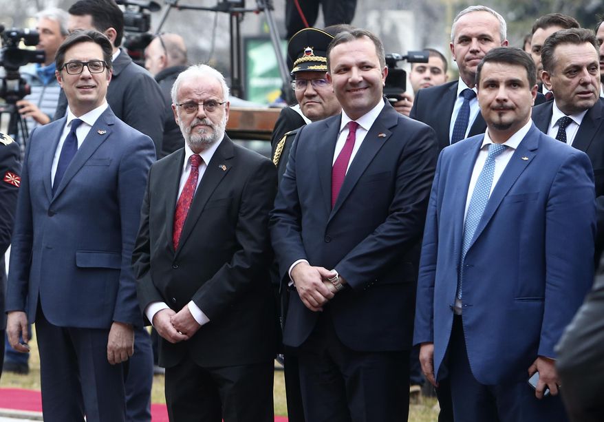 From left, North Macedonia's head officials: President Stevo Pendarovski, the Parliament speaker Talat Xhaferi, the Prime Minister Oliver Spasovski and the President of the NATO Parliamentary Assembly Attila Mesterházy from Hungary attend the raising of the NATO flag ceremony in front of the parliament building in Skopje, North Macedonia, on Tuesday, Feb. 11, 2020. North Macedonia's parliament has passed the law on ratification of NATO treaty on Tuesday, the last step this small Balkan nation to become the 30-th full-flagged member of Western military alliance. (AP Photo/Boris Grdanoski)
