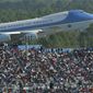 FILE - In this Feb. 15, 2004, file photo, Air Force One rises above the packed grand stands along the super stretch at Daytona International Speedway in Daytona Beach, Fla. Bush arrived before the race, talked with drivers along pit road and gave the command for drivers to start their engines. President Donald Trump will look to rev up his appeal with a key voting demographic Sunday — NASCAR fans — as he takes in the Daytona 500. (Jim Tiller/Daytona Beach News-Journal Pool via AP)