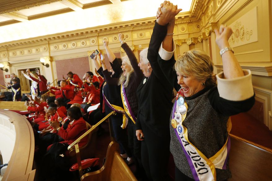 FILE This Monday Jan. 27, 2020 file photo shows Equal Rights Amendment supporter Donna Granski, right, from Midlothian Va., cheers the passage of the House ERA Resolution in the Senate chambers at the Capitol in Richmond, Va. The resolution passed 27-12. In a state once synonymous with the Old South, Democrats are using their newfound legislative control to refashion Virginia as the region's progressive leader on racial, social and economic issues. (AP Photo/Steve Helber)