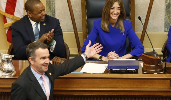 Virginia Gov. Ralph Northam, bottom left, as he recognizes House speaker, Eileen Filler-Corn, D-Farifax, right, while he prepares to deliver his State of the Commonwealth address as Lt. gov. Justin Fairfax, top left, applauds before a joint session of the Virginia Assembly at the Virginia state Capitol in Richmond, Va. (AP Photo/Steve Helber)