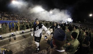 Los Angeles Kings defenseman Kurtis MacDermid is congratulated by cadets while heading back to the locker room after the team&#39;s NHL hockey game against the Colorado Avalanche on Saturday, Feb. 15, 2020, at Air Force Academy, Colo. The Kings won 3-1. (AP Photo/David Zalubowski)