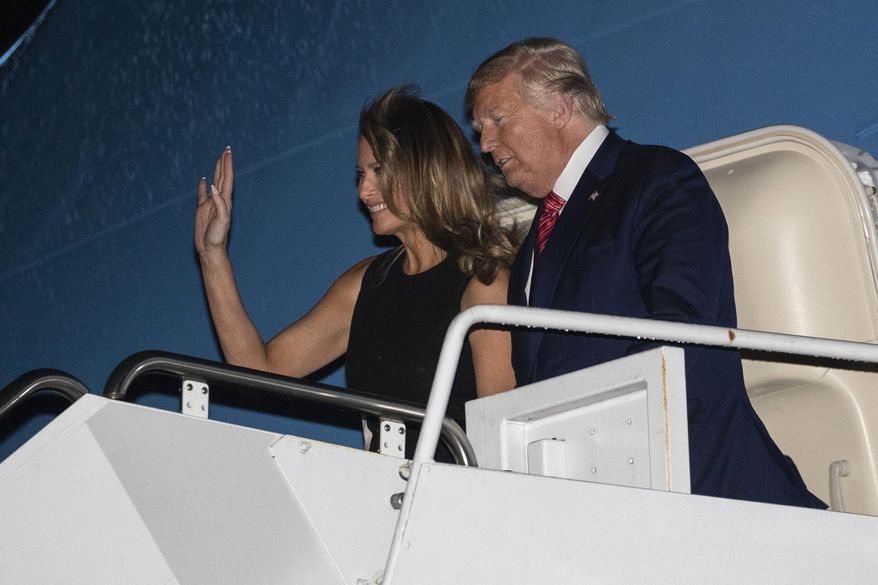 President Donald Trump, accompanied by first lady Melania Trump, steps off Air Force One at the Palm Beach International Airport, Friday, Feb. 14, 2020, in West Palm Beach, Fla. (AP Photo/Alex Brandon)