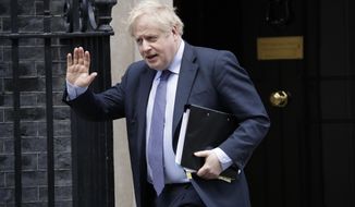 FILE - In this file photo dated Wednesday, Feb. 12, 2020, British Prime Minister Boris Johnson waves at the media as he leaves 10 Downing Street in London.  Johnson has come under pressure to dismiss adviser Andrew Sabisky, who wrote offensive comments about race and intelligence in 2014, it has been revealed Monday Feb. 17, 2020, while a Downing Street spokesman sought to distance the government from the views expressed by advisor Sabisky. (AP Photo/Matt Dunham, FILE)