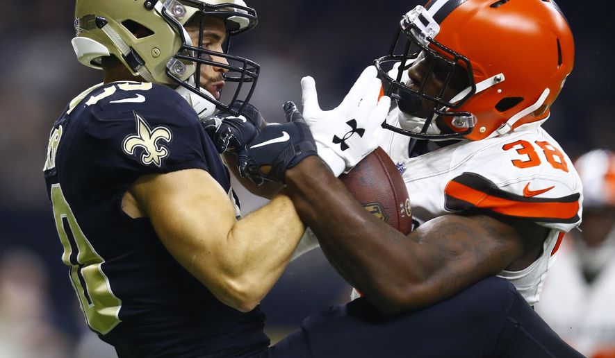 FILE - In this Sept. 16, 2018, file photo, New Orleans Saints wide receiver Austin Carr, left, cannot hold on to the football as Cleveland Browns defensive back T.J. Carrie (38) defends during the first half of an NFL football game in New Orleans. New Browns general manager Andrew Berry cleared $13 million in salary-cap space Monday, Feb. 17, 2020, by releasing veteran cornerback Carrie and three others players signed by former GM John Dorsey. (AP Photo/Butch Dill, File)