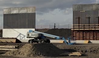 In this Nov. 7, 2019, photo, the first panels of levee border wall are seen at a construction site along the U.S.-Mexico border, in Donna, Texas. The Trump administration said Tuesday, Feb. 18, 2020, that it will waive federal contracting laws to speed construction of the border wall with Mexico. (AP Photo/Eric Gay) **FILE**