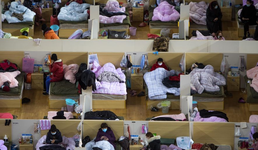 In this Monday, Feb. 17, 2020, photo released by Xinhua News Agency, patients infected with the coronavirus take rest at a temporary hospital converted from Wuhan Sports Center in Wuhan in central China&#x27;s Hubei Province. China reported thousands new virus cases and more deaths in its update Tuesday on a disease outbreak that has caused milder illness in most people, an assessment that promoted guarded optimism from global health authorities. (Xiao Yijiu/Xinhua via AP)
