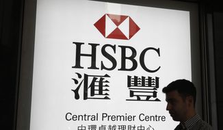 FILE - In this May 4, 2018, file photo, a man walks past a branch of HSBC bank in Hong Kong. Europe&#39;s biggest bank has reported that its net profit fell 53% in 2019 to $6 billion. London-based HSBC, whose profit is mainly from Asia, said it plans to revamp its U.S. and European business and shed $100 billion in assets to improve its profitability.  (AP Photo/Kin Cheung, File)