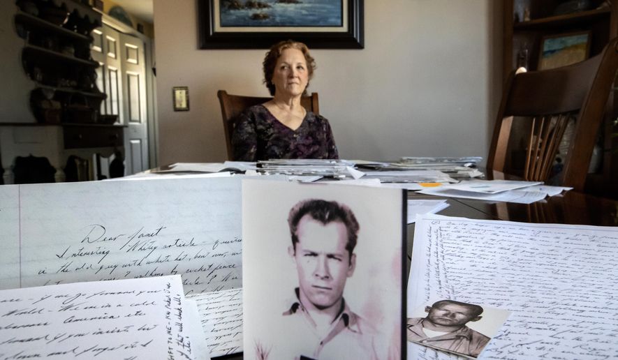 Janet Uhlar sits for a photo at her dining room table with an arrangement of letters and pictures she received through her correspondence with imprisoned Boston organized crime boss James &amp;quot;Whitey&amp;quot; Bulger, Friday, Jan. 31, 2020, in Eastham, Mass. Uhlar was one of 12 jurors who found Bulger guilty in a massive racketeering case, including involvement in 11 murders. But now she says she regrets voting to convict Bulger on the murder charges, because she learned he was an unwitting participant in a secret CIA experiment in which he was dosed with LSD on a regular basis for 15 months. (AP Photo/David Goldman)